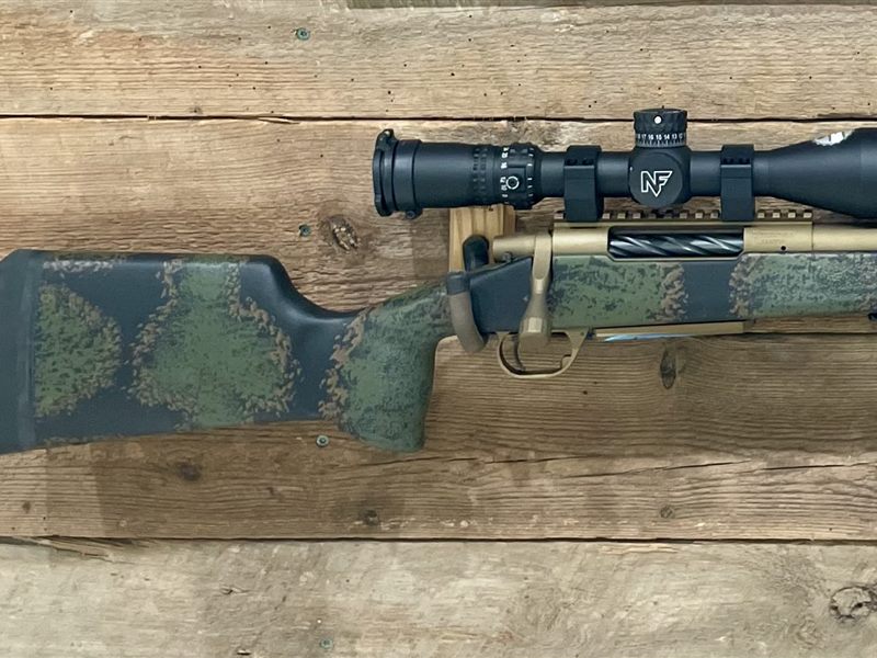 Custom-finished bolt rifle with camo stock and bronze barrel